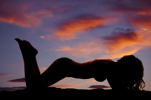 Silhouete woman sunset swimwear face down — Stock Photo, Image