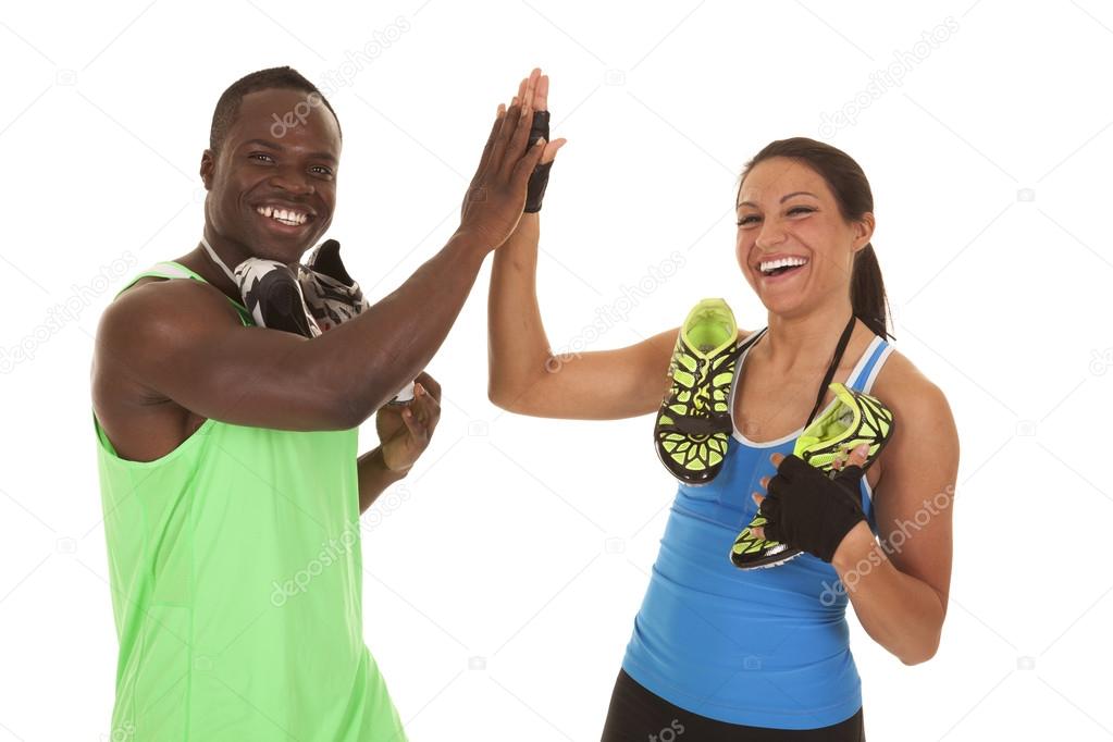 fitness man woman with shoes high five