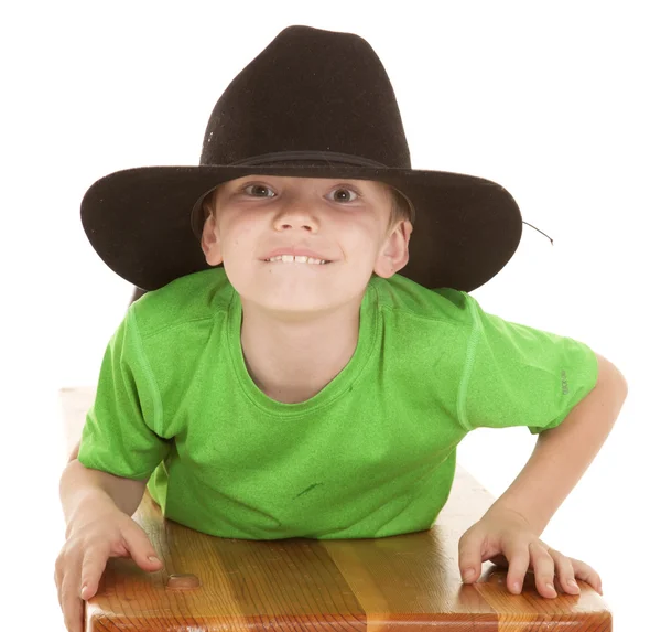 Boy green shirt cowboy hat lay looking — Stock Photo, Image