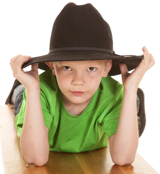 Boy green shirt cowboy hat look serious lay — Stock Photo, Image