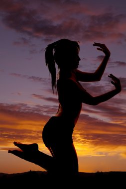 Silhouette fitness on knees hand out feet up