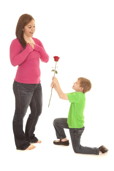 Boy on knee rose to girl — Stock Photo, Image