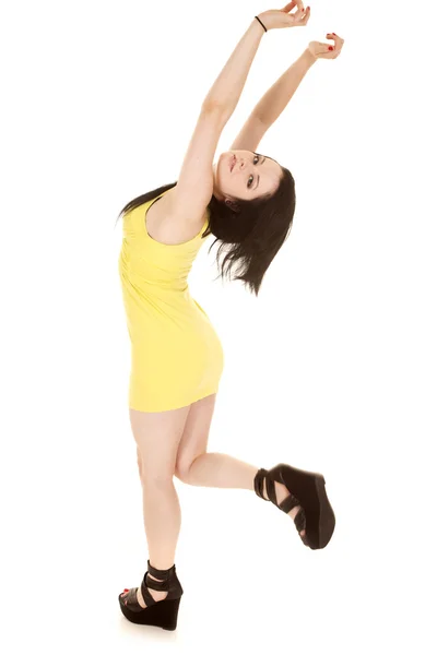 Woman yellow short dress stand hands up — Stock Photo, Image