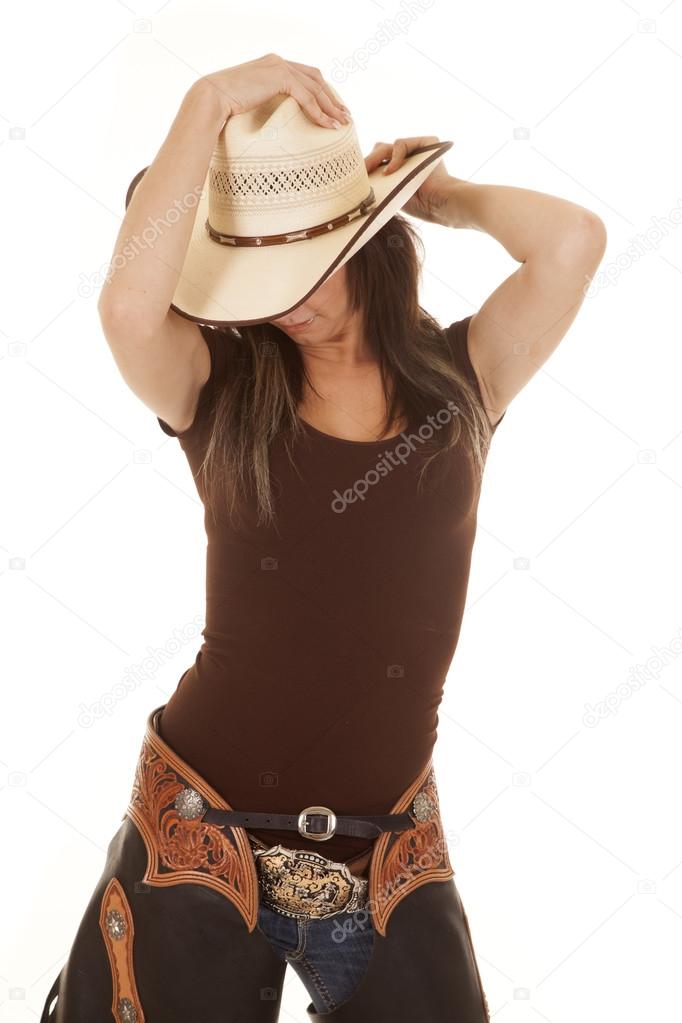 western woman brown shirt hat look down