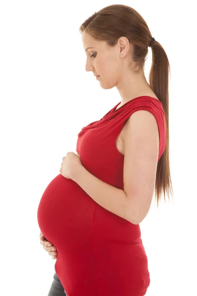 Pregnant woman red shirt side look down — Stock Photo, Image