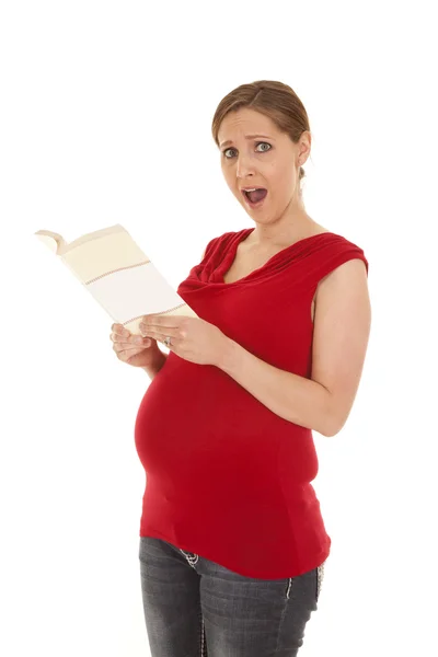Pregnant in red shirt shocked with book — Stock Photo, Image
