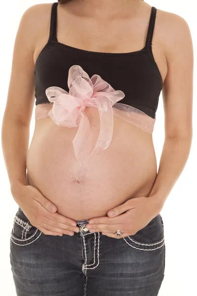 Pregnant belly with a pink bow on it — Stock Photo, Image