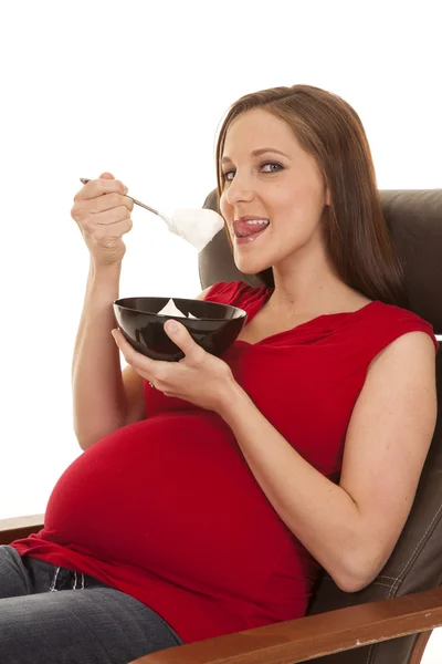 Pregnant red shirt lick spoon — Stock Photo, Image