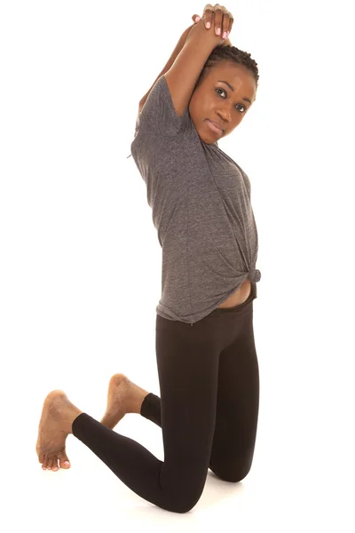 Woman in gray shirt fitness stretch on knees — Stock Photo, Image