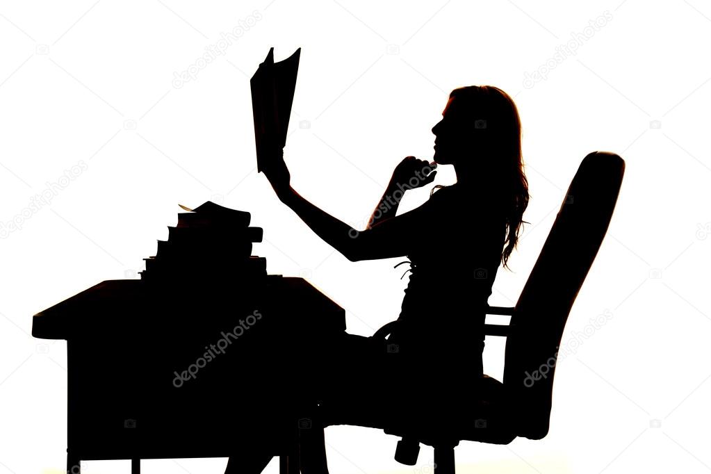 silhouette woman at desk book up thinking