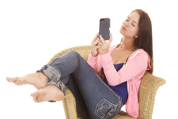Girl kissy face on her phone sitting Stock Image