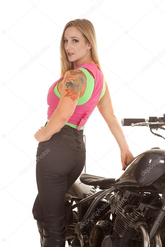 Woman stand back to motorcycle tattoo