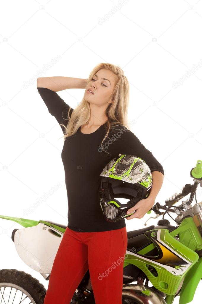 woman red pants green motorcycle holding helmet