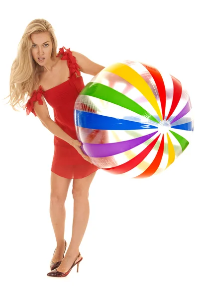 Woman red dress beach ball lean over — Stock Photo, Image