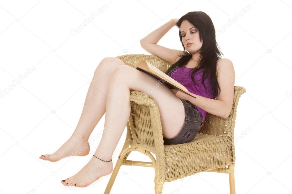 woman purple in chair reading