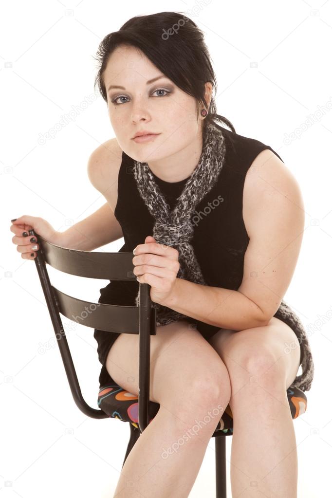 woman black dress scarf sit lean forward