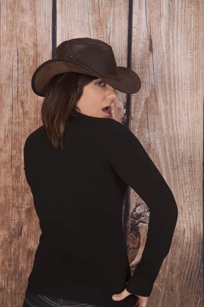 Woman cowgirl wooden wall back shock — Stock Photo, Image