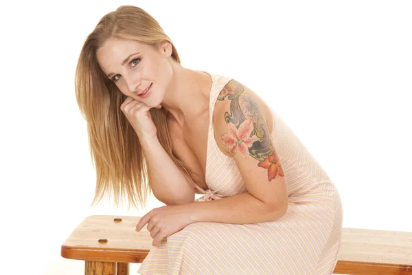 Woman stripe dress tattoo sit smile lean — Stock Photo, Image