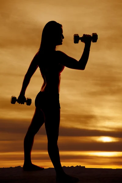 Silhouette woman hammer curl — Stock Photo, Image