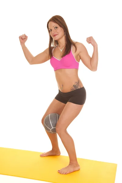 Woman pink bra shorts fitness ball between legs flex — Stock Photo, Image