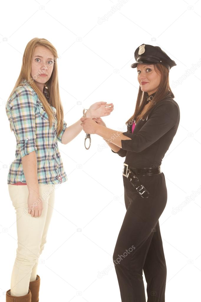 Woman cop handcuff woman looking