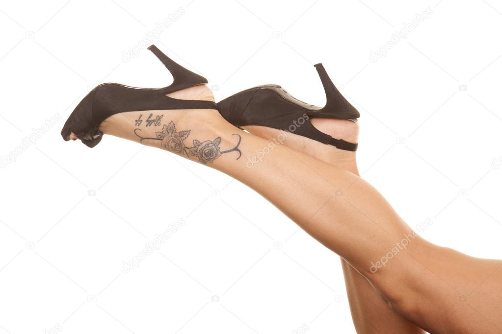 Woman legs tattoo on foot toes down