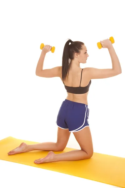 Woman fitness blue shorts knees back weights up — Stock Photo, Image