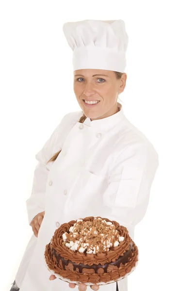 Woman baker cake hold out — Stock Photo, Image
