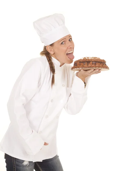 Woman baker cake lick — Stock Photo, Image