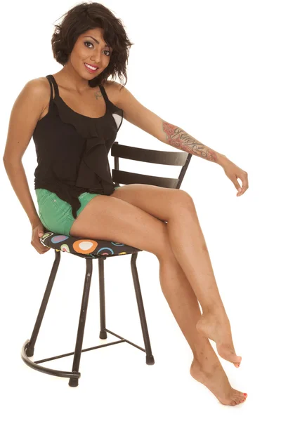 Hispanic woman sit chair red lips legs out smile — Stock Photo, Image