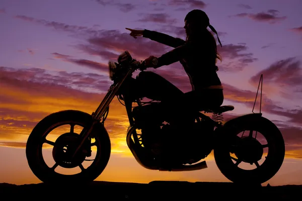 Silhouette woman motorcycle ride pointing — Stock Photo, Image