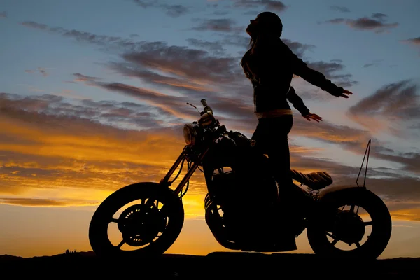 Silhouette woman motorcycle stand hands back — Stock Photo, Image