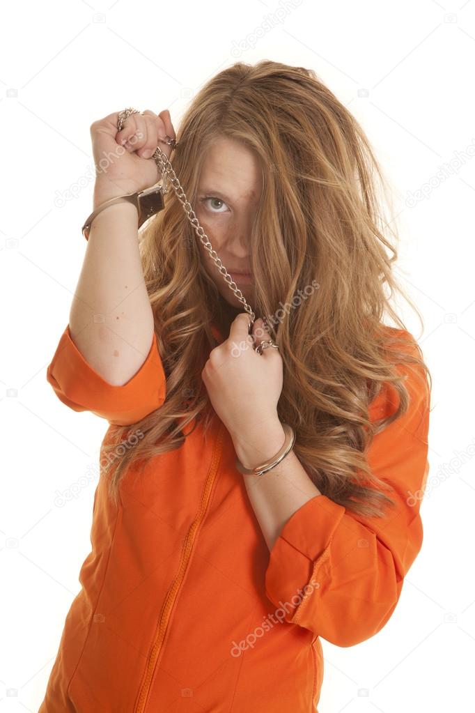 Woman inmate cuffs messed up hair sad