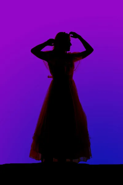Silhouette woman dress arms by head — Stock Photo, Image