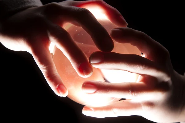 Hands on lighted ball — Stock Photo, Image
