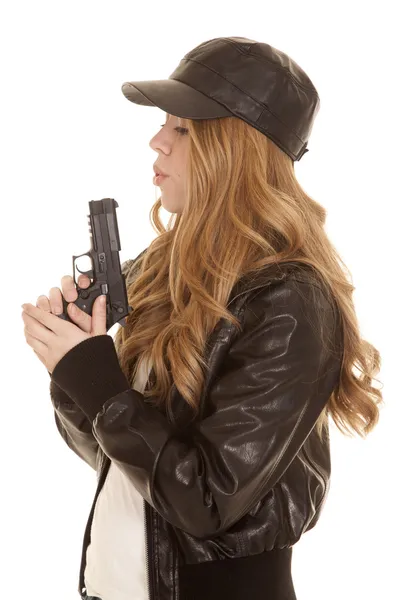 Woman leather pistol blow side — Stock Photo, Image