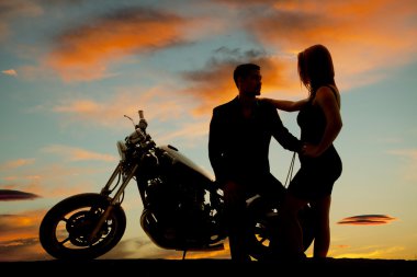 silhouette of woman by man on motorcycle clipart
