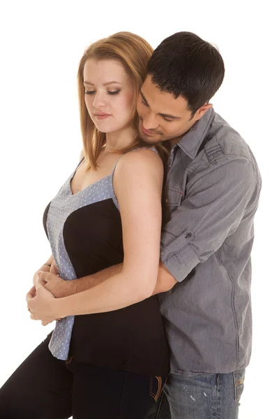 Couple casual his arms around her eyes down Stock Photo