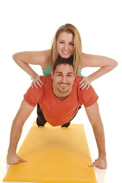 Man pushup woman on back smiles — Stock Photo, Image