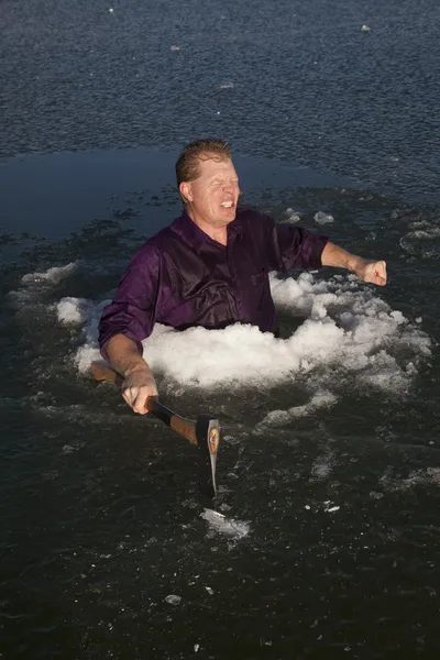 Man in ice hole hold axe freezing — Stock Photo, Image