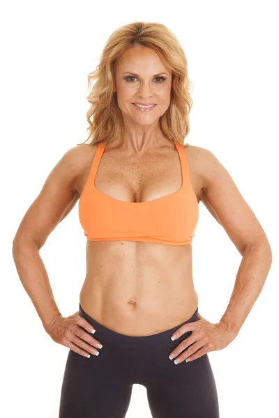 Mature woman orange bra stand hands hips — Stock Photo, Image