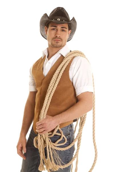 Cowboy in vest with rope on shoulder — Stock Photo, Image