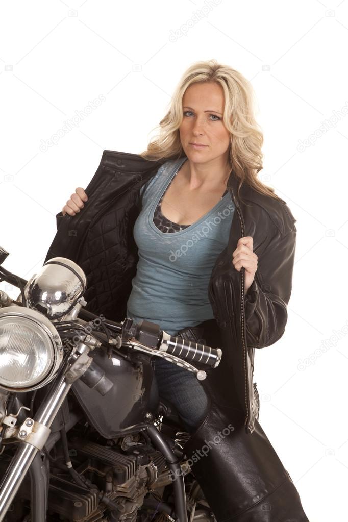Woman open leather jacket sit on motorcycle