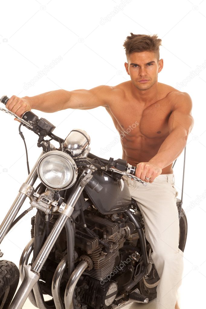 man no shirt on motorcycle very serious