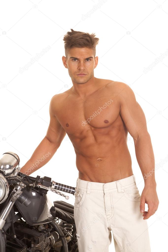 man no shirt stand by motorcycle very serious