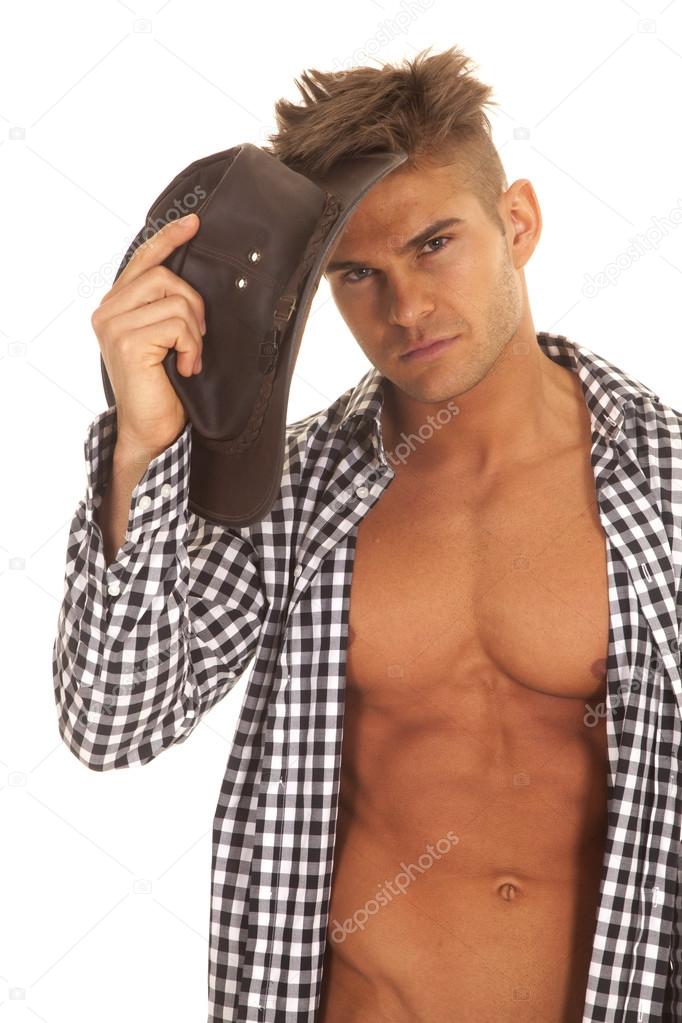 man with open shirt hold hat by head