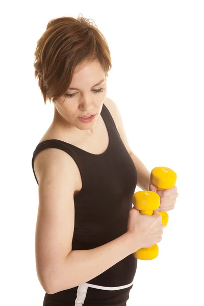 Latin woman yellow weight twist look down — Stock Photo, Image