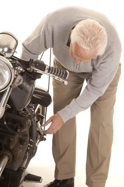 Elderly man check motorcycle — Stock Photo, Image