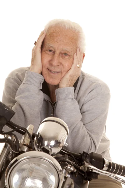 Elderly man on motorcycle close hands face — Stock Photo, Image