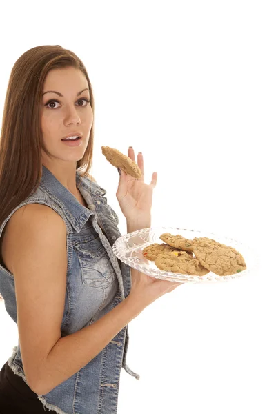 Woman denim vest cookies hold one serious — Stock Photo, Image